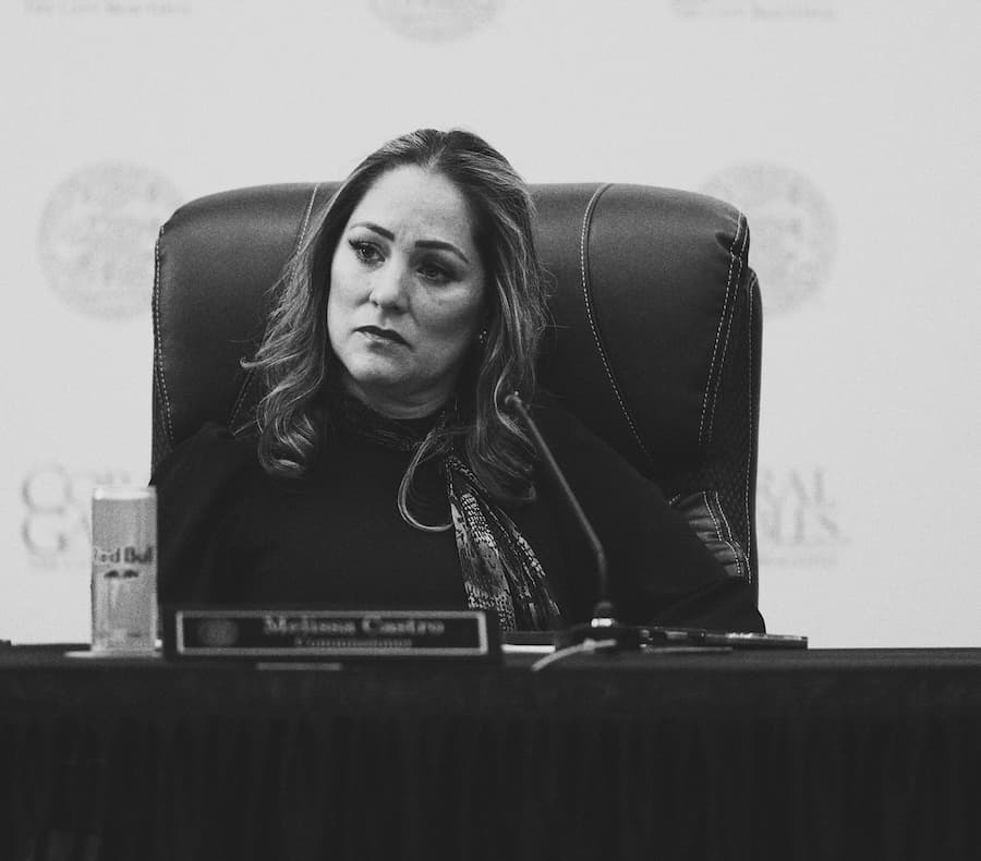 Commissioner Melissa Castro seated at the Coral Gables dais, black and white
